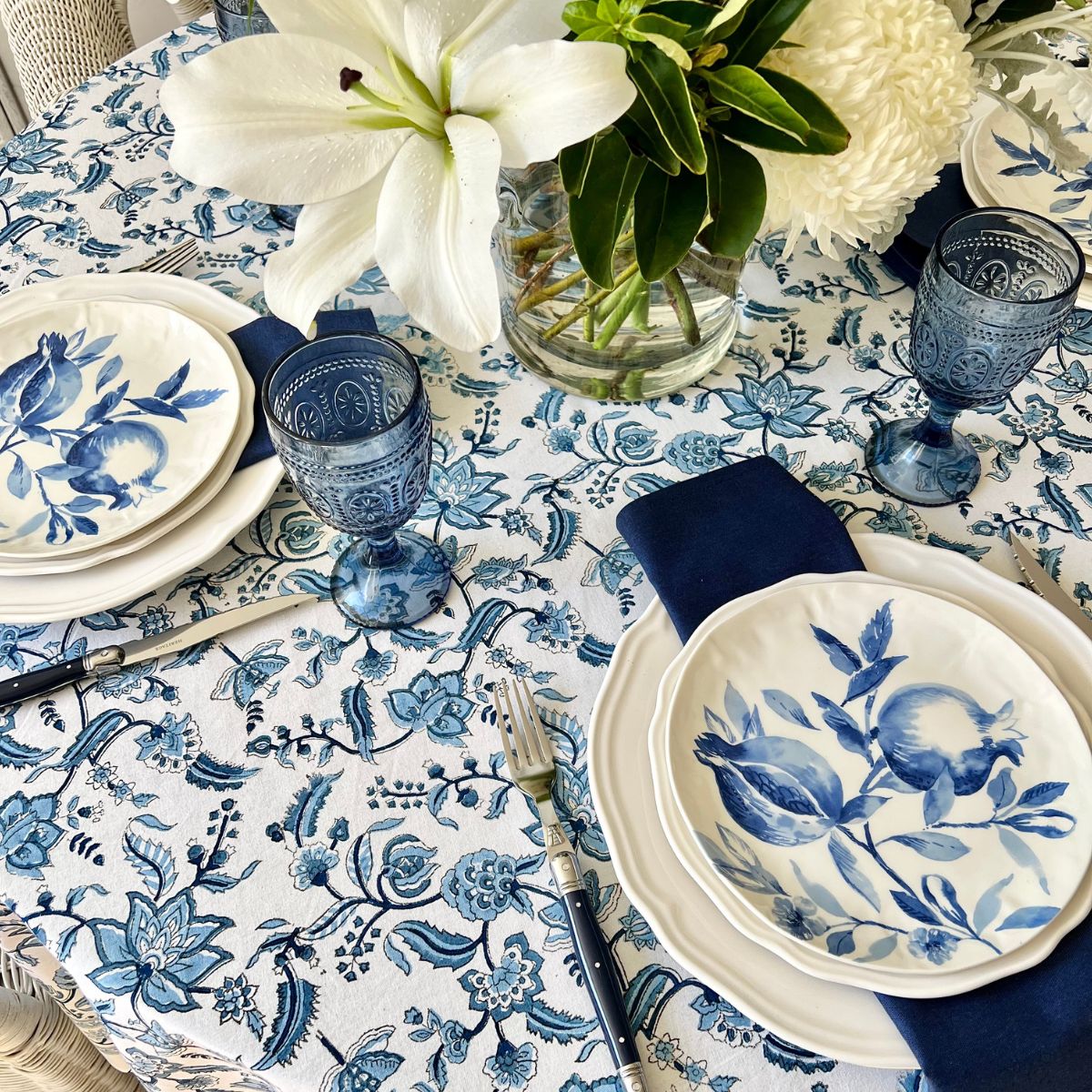 Top view of 152 cm Chintz monochrome blue hand block printed cotton round tablecloth for a 4 seater dining table, a rich and elegant everyday table linen that brings warmth and depth to winter table styling.