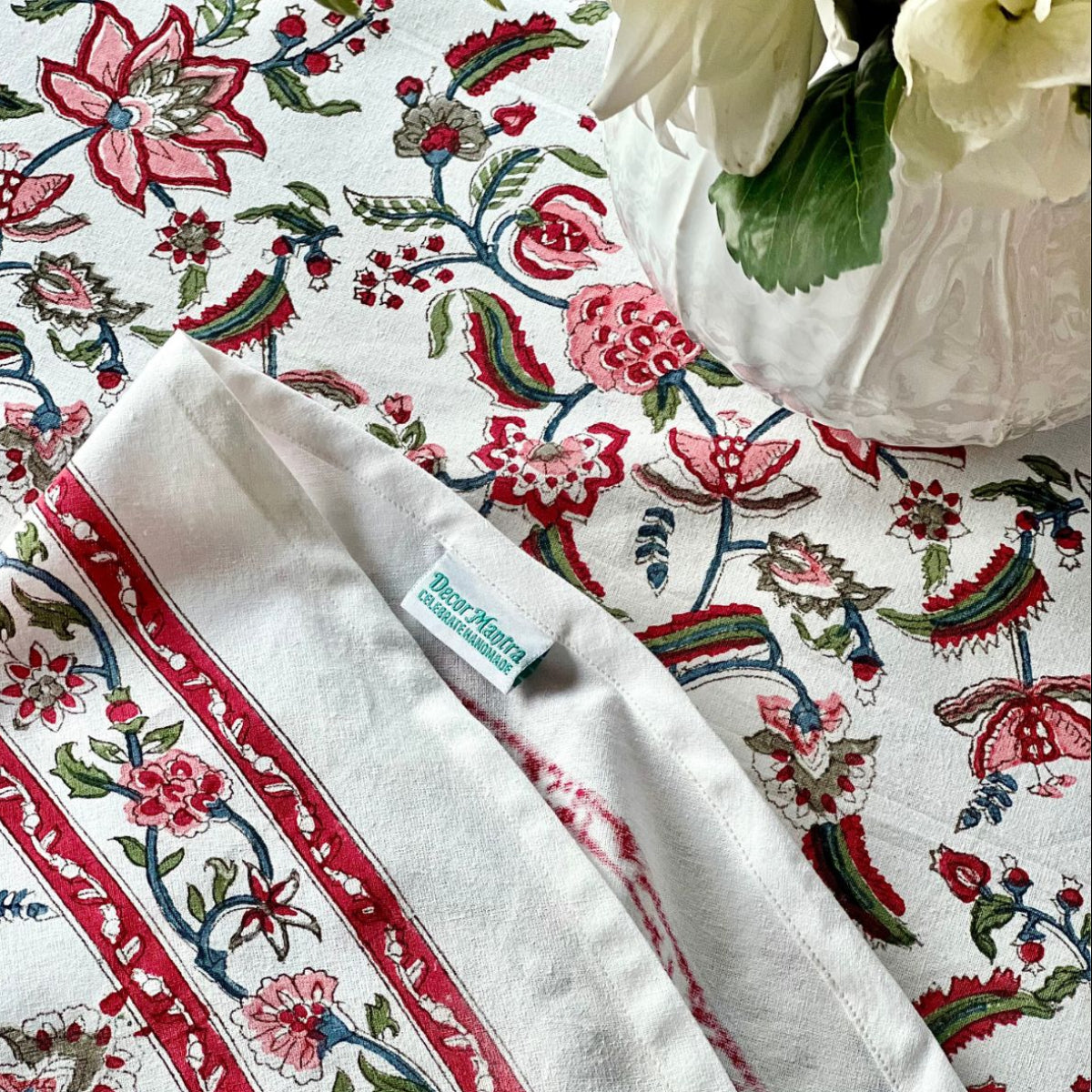 A 180 cm Chintz multicoloured hand block printed cotton round tablecover for a vibrant special occasion table, the red pomegranate pattern and complementary border makes it rich for every celebration.
