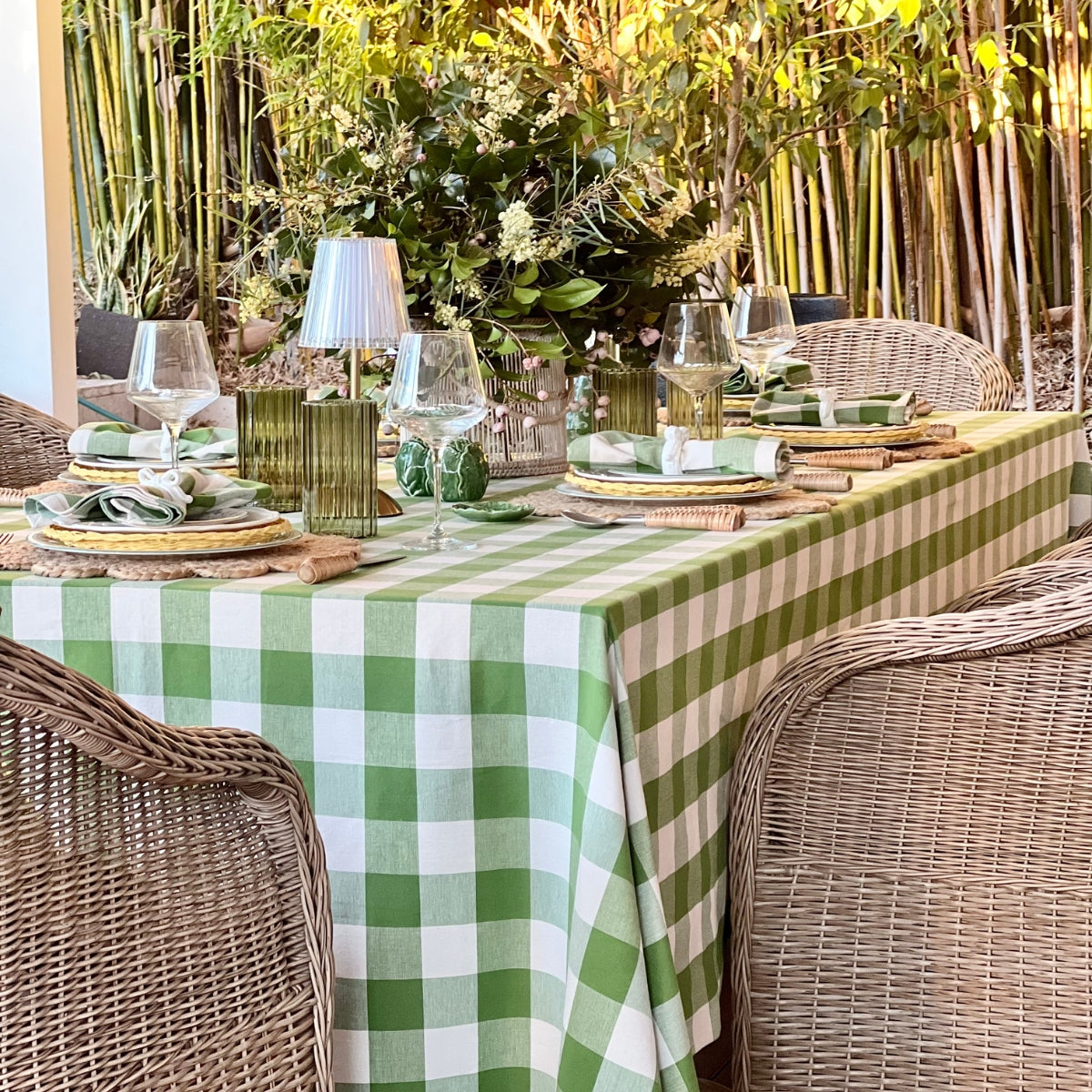A handwoven green gingham check table linen styled for an alfresco brunch, adding a garden-fresh touch.