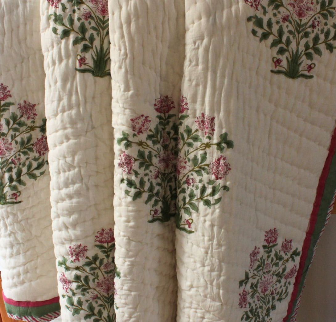 Quilt with floral patterns on a plain background