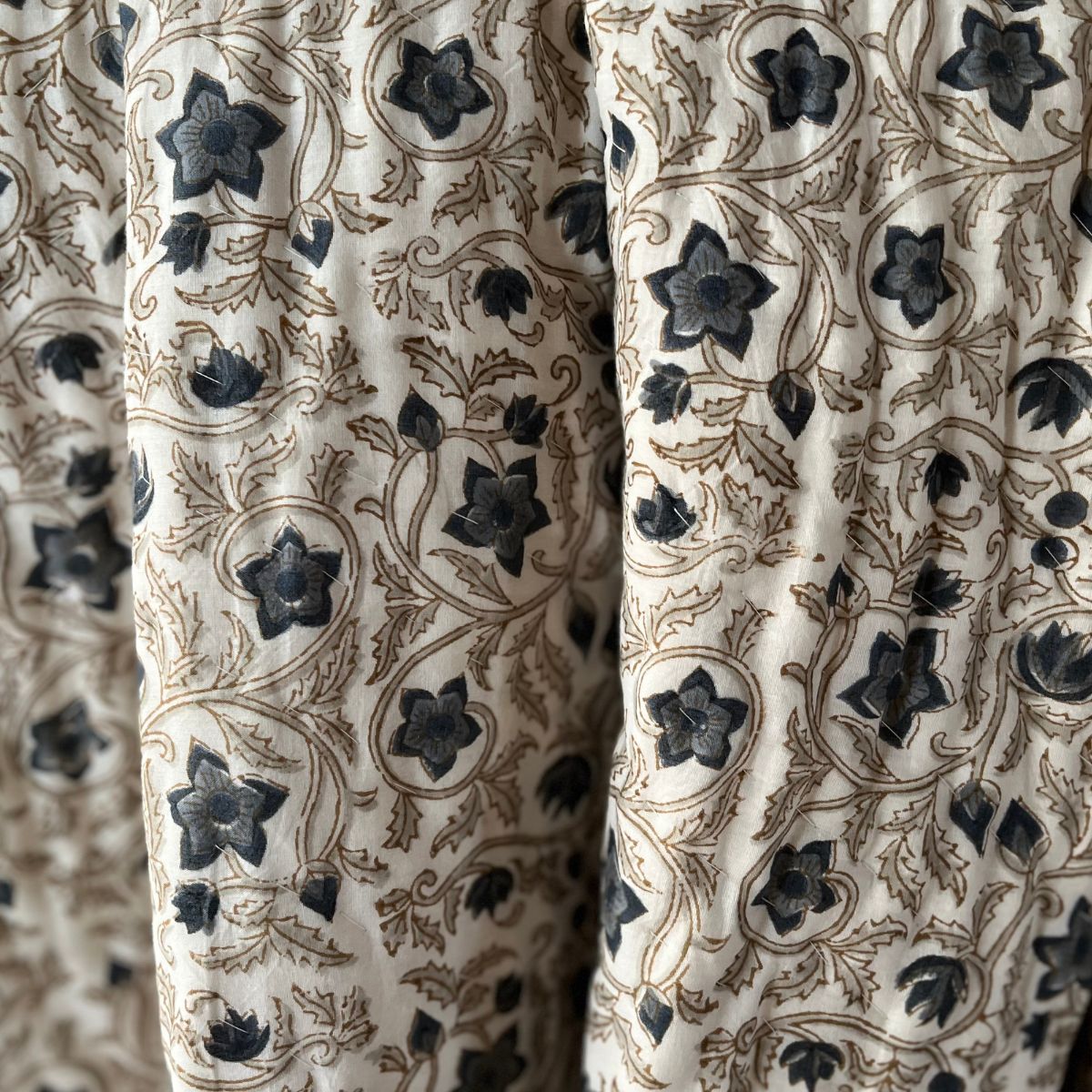 Artisan-crafted reversible cotton quilt featuring traditional floral block prints, pure cotton filling, and lightweight breathable comfort for every season.