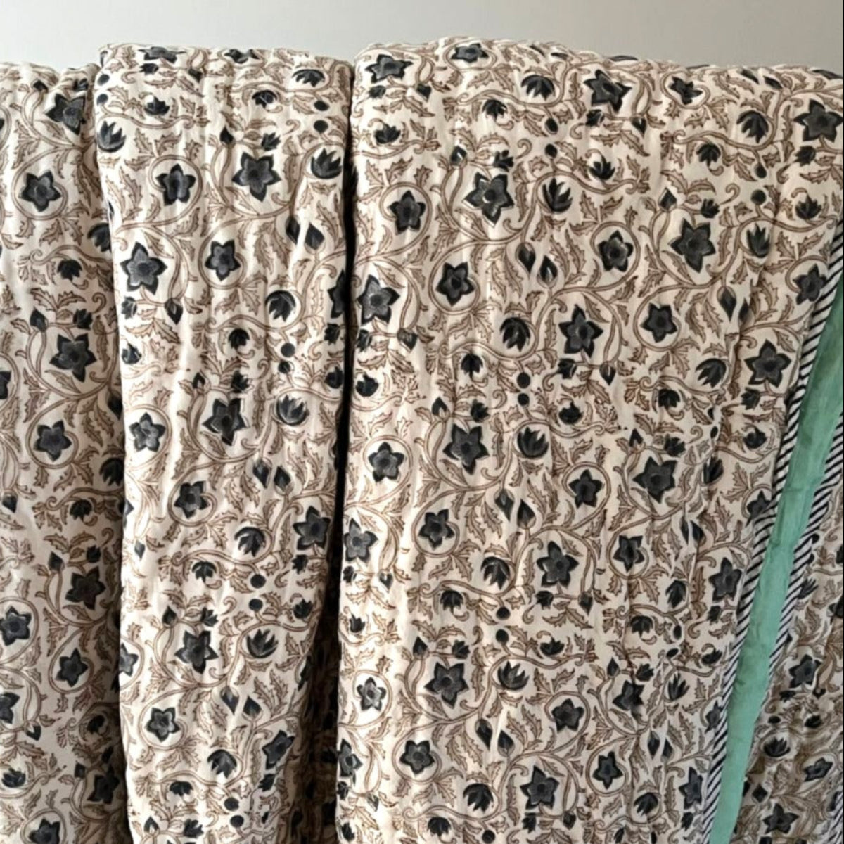 Stella blue and green reversible cotton quilt featuring hand block printed floral pattern and artisan hand quilting.
