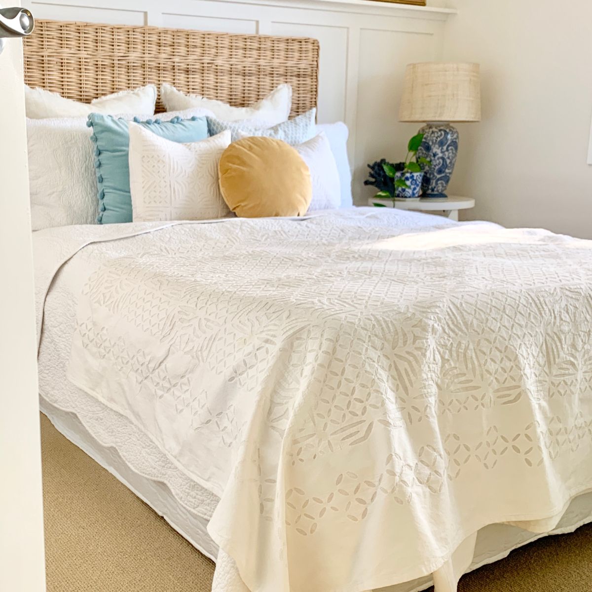 Applique bed spread displayed on a king bed with applique cushion of 45 cm
