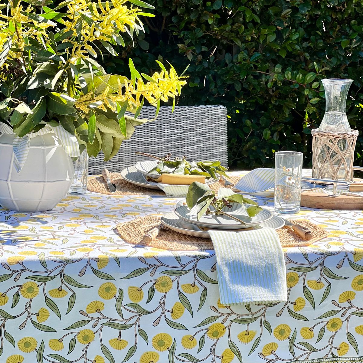 Hand block printed square tablecloth featuring Australian native yellow green gums floral pattern on cotton.