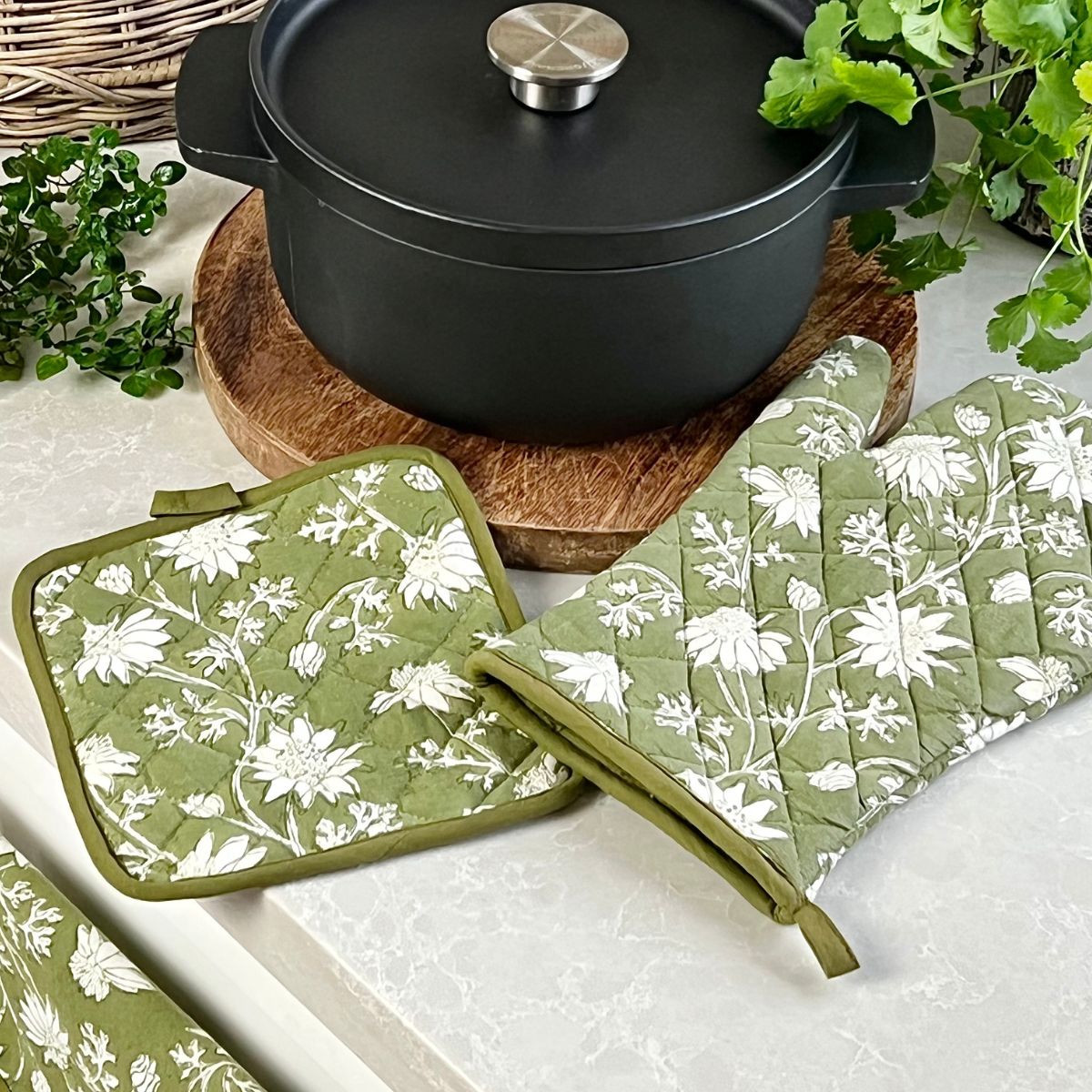 Hand block printed pot holder placed beside a cooking pot, showcasing its quilted construction and functional kitchen use. Perfect for gifts for Christmas, Mother's day and Housewarming