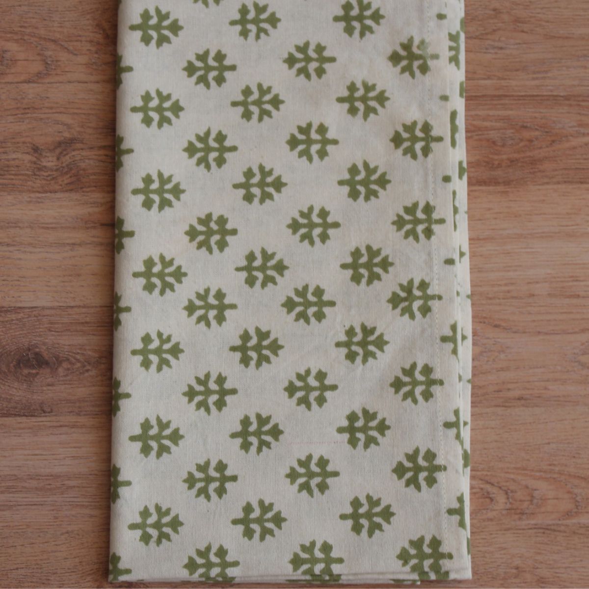 Folded Flannel Foliage cotton napkin on a neutral background showcasing the hand block printed leaf pattern, premium cotton fabric, and artisan detailing.