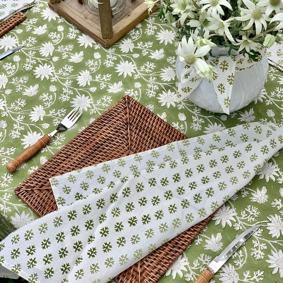 Flannel leaf napkin and fresh floral centerpiece styled on the Flannel Flowers square tablecloth, showcasing coordinated botanical styling.