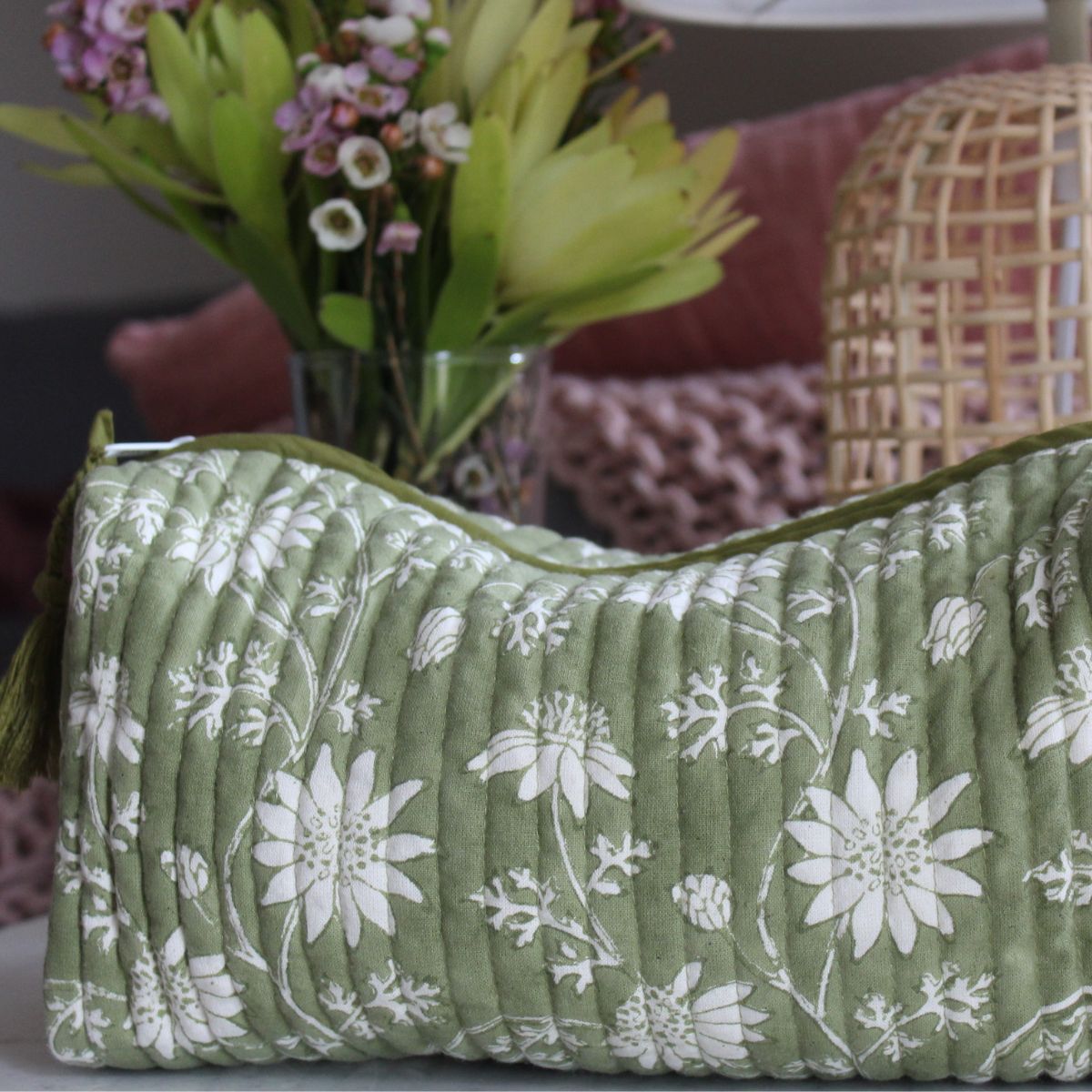 Flannel Flowers quilted travel bag featuring floral block print motifs, cotton lining, built-in pockets, and artisan-made quality for everyday organization.