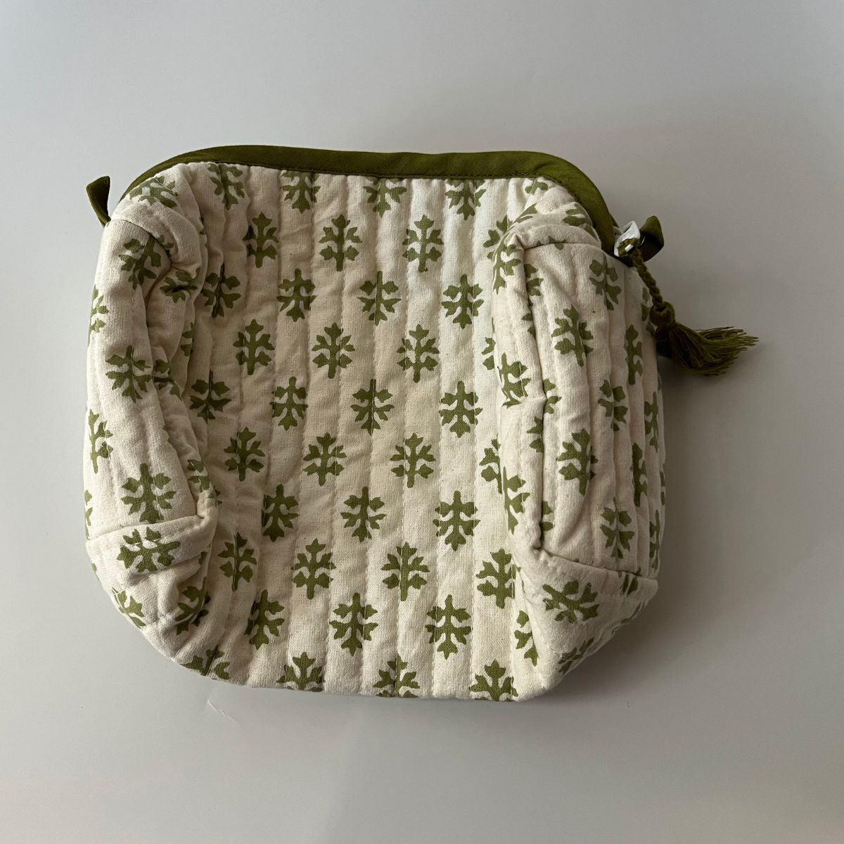 Hand block printed Flannel Flowers wash bag in small size, displayed on a neutral background, highlighting quilted detailing, zipper closure, and versatile everyday functionality.