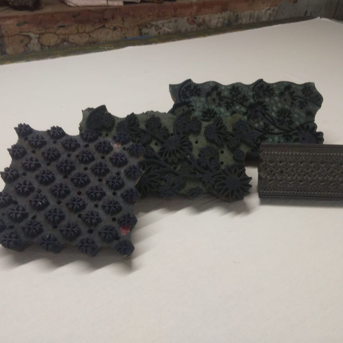 Traditional hand-carved wooden printing blocks used to create the Flannel Flowers pattern through centuries-old Indian block printing techniques.