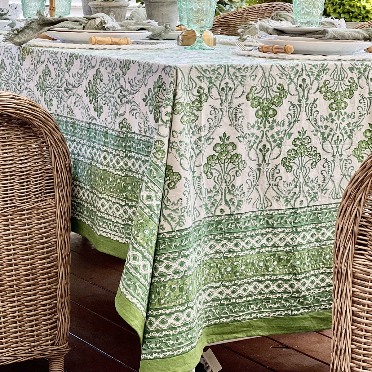 Side view of a rectangular green hand block printed tablecloth in 150 x 285 cm showing the intricate layered border and a neat drape, seats 8 to 10
