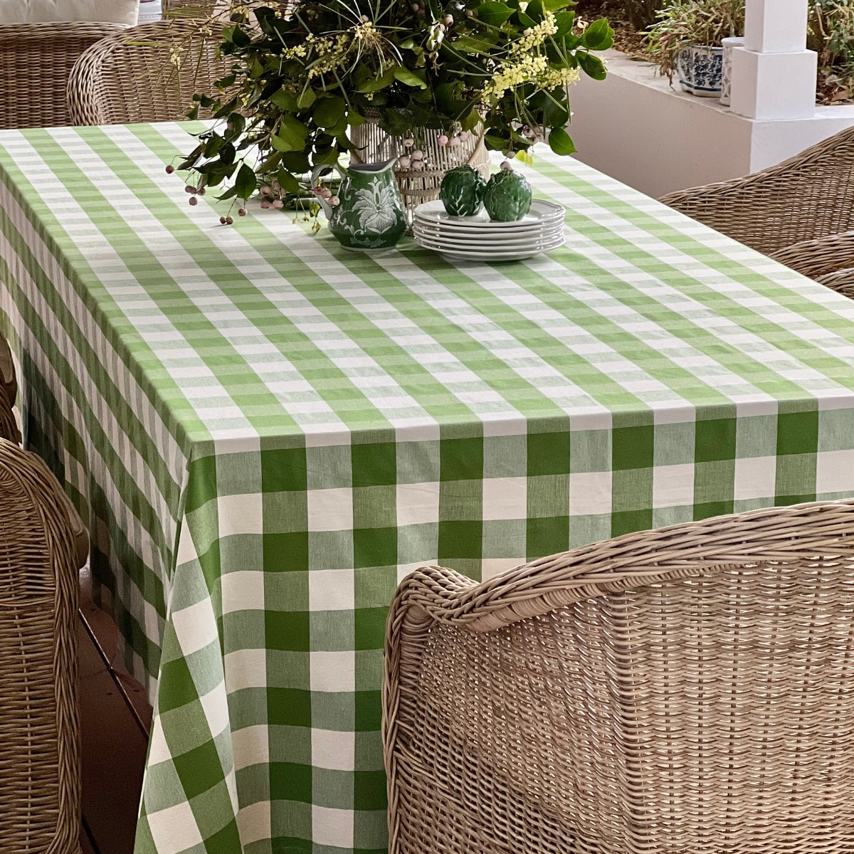 Green gingham checked tablecloth  on a dining table with natural light.