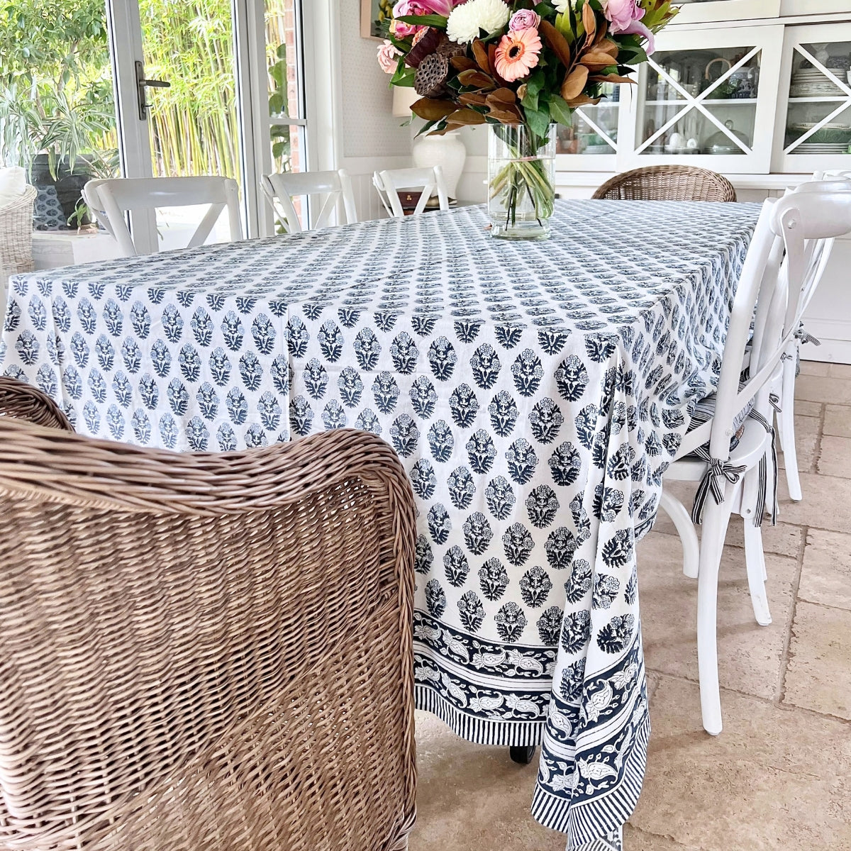 Long rectangular blue floral hand block printed tablecloth in 180 x 340 cm dressing a sunroom dining table that seats 10 to 12 guests