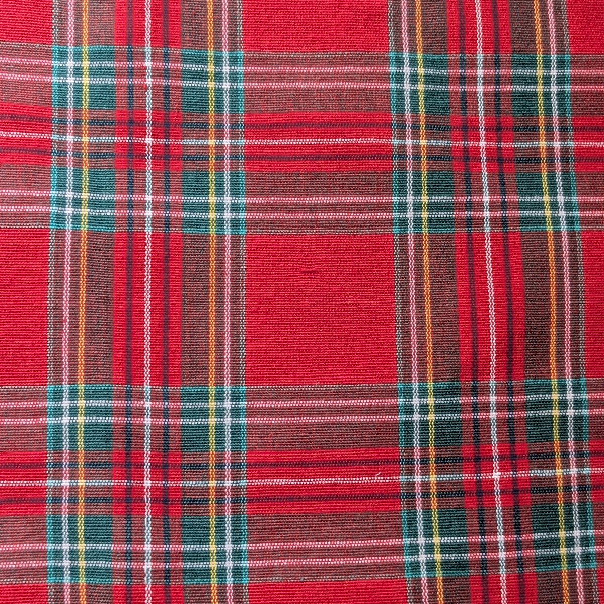 Close-up of red plaid fabric with multicolor pattern