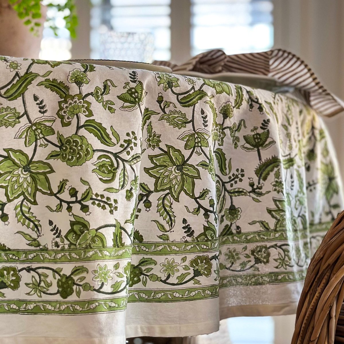 
Side view of 180 cm Chintz monochrome green hand block printed cotton round tablecover for a casual 6 seater circular dining table, a versatile everyday table linen for relaxed alfresco Australian outdoor dining.