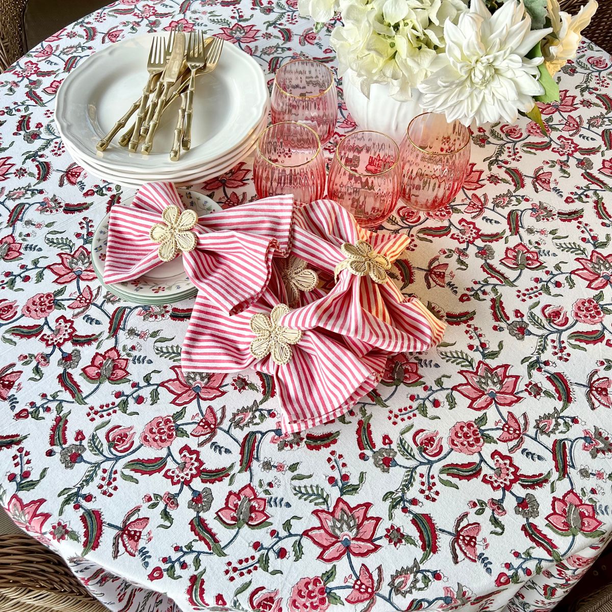 
A 220 cm multicoloured cotton round tablecloth featuring an Indian block printed floral chintz pattern on an 8 seater circular table.