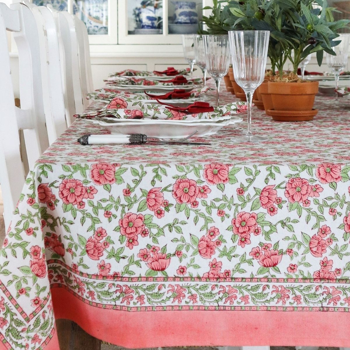 Close up of Block printed cotton floral tablecloth on large rectangular table in festive setting