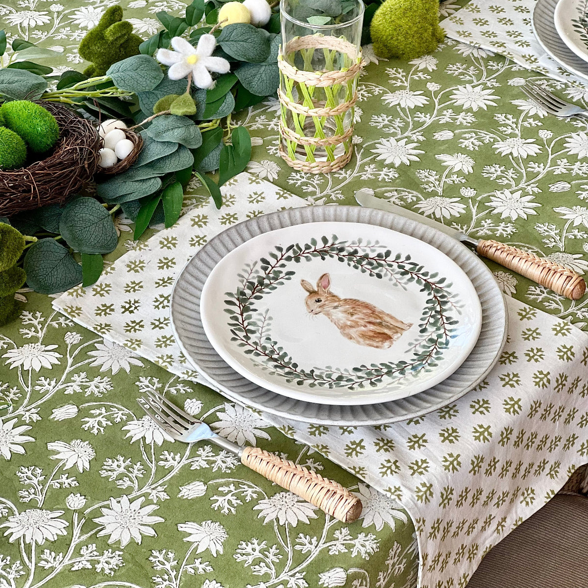 Flannel Foliage napkins arranged on a casual dining table with stacked dishes and cutlery, perfect for family meals and informal gatherings.