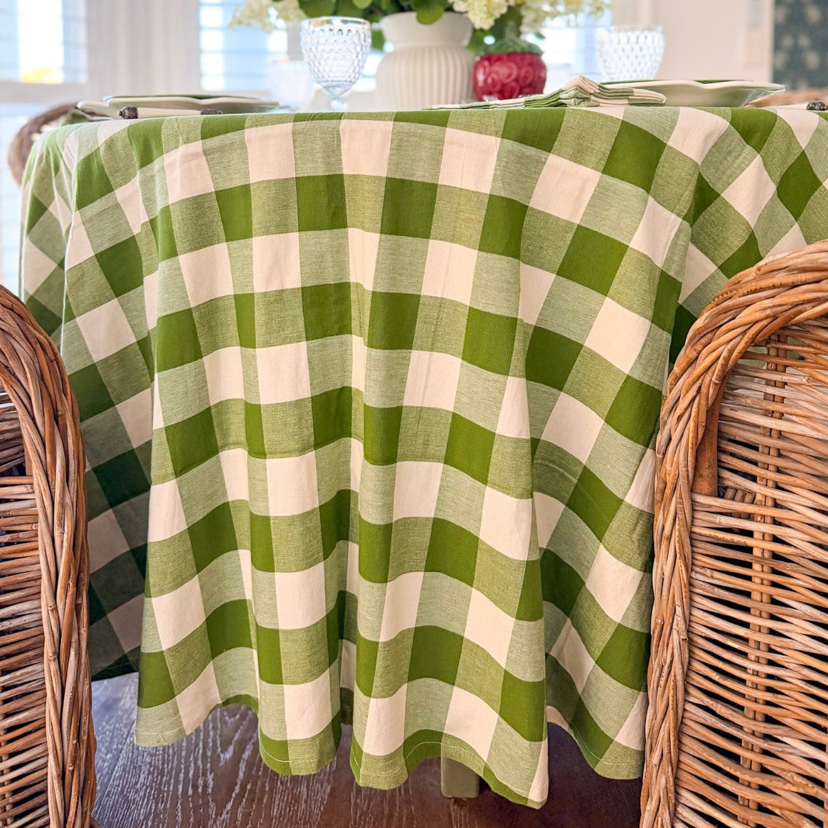 A 225 cm round green gingham handwoven table linen on a large 8 seater circular table styled for summer hosting