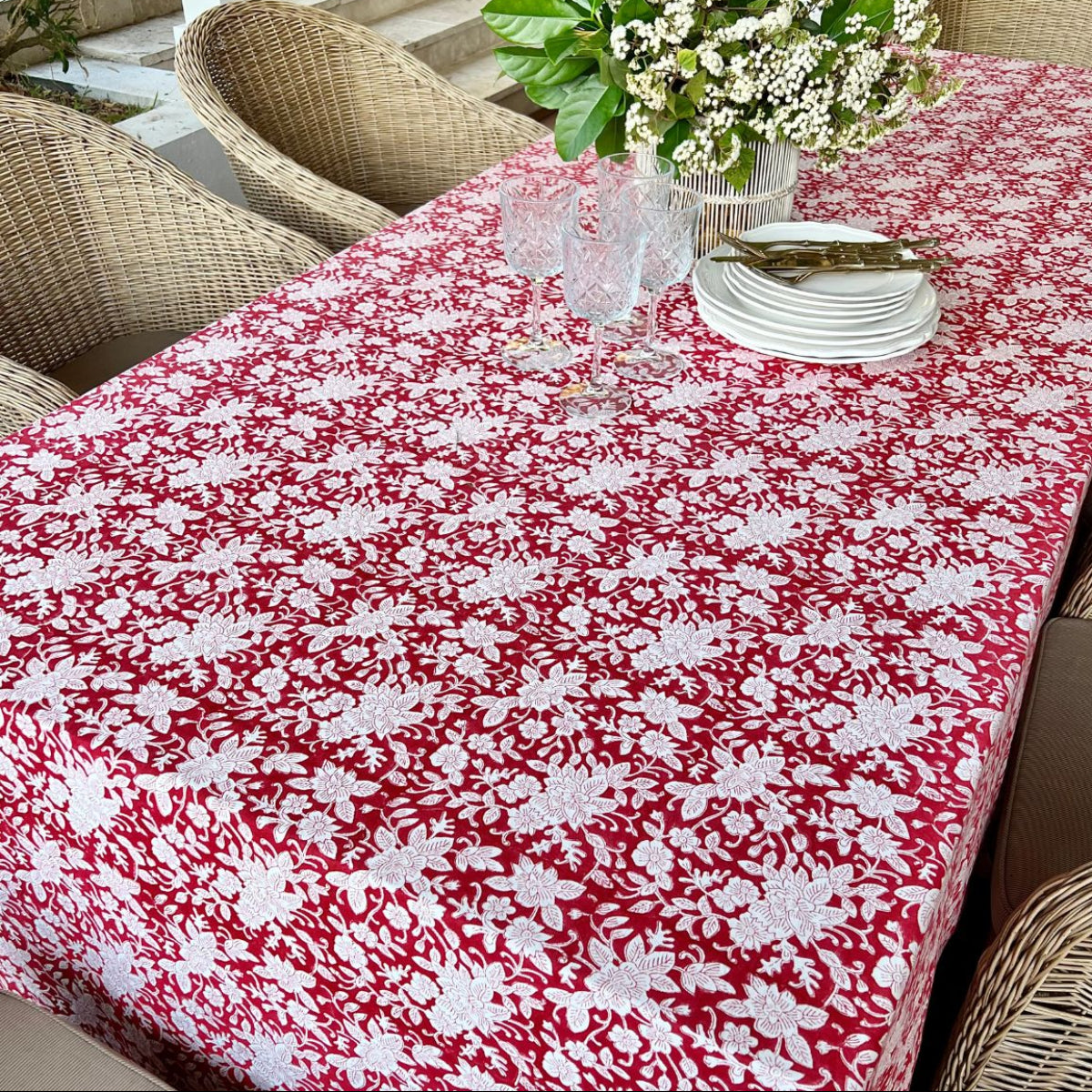 
A 180 x 180 cm red and white floral hand block printed square tablecover for a casual 6 seater dining table, a vibrant everyday table linen for informal Australian gatherings.