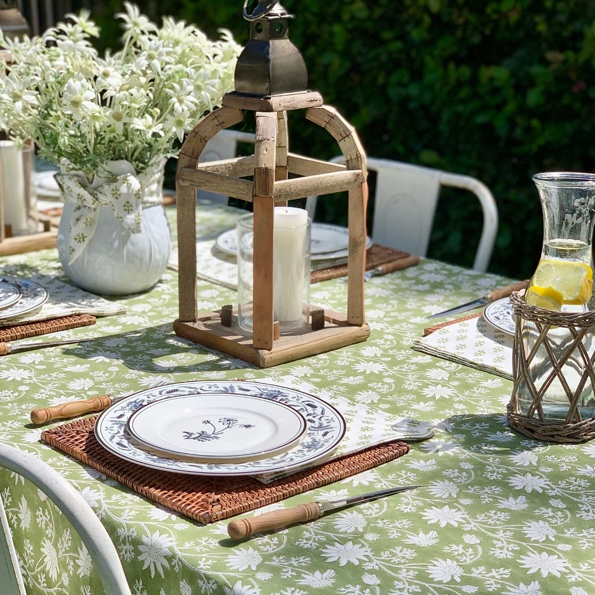 
150 x 280 cm Flannel Flowers tablecloth styled outdoors with white dinnerware for a relaxed family lunch and everyday entertaining.