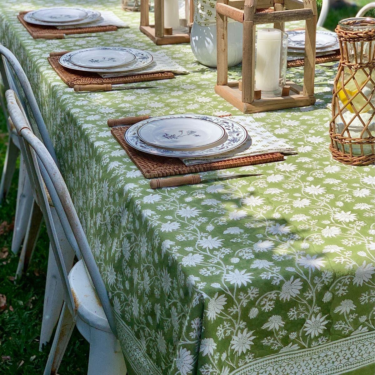 A large Flannel Flower hand block printed cotton tablecloth creating a welcoming outdoor setting for an elegant Australian summer wedding