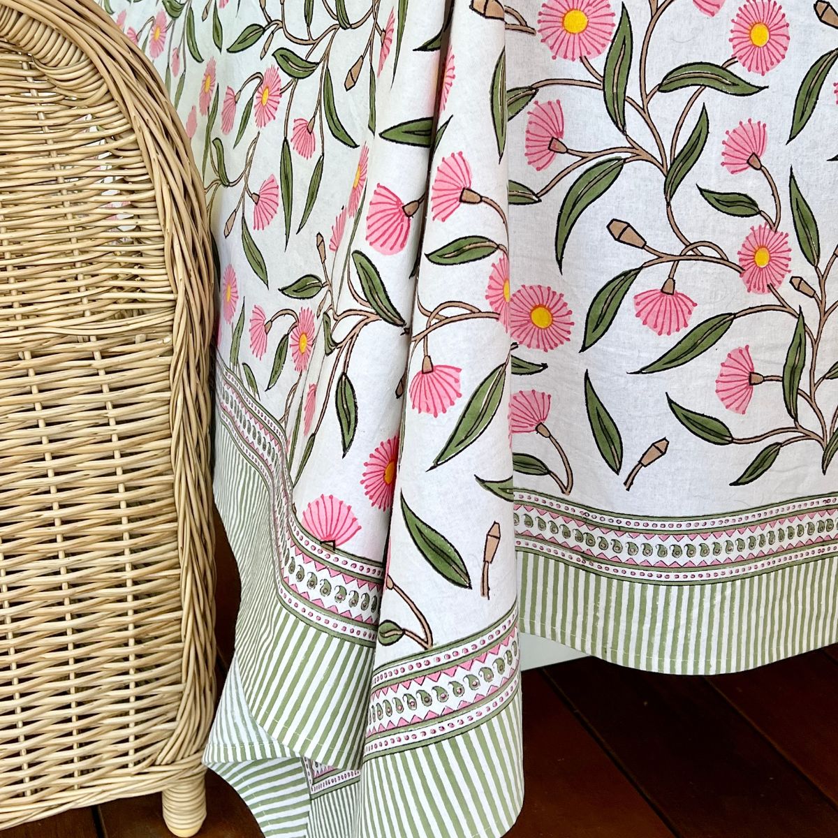 Corner close-up of the Pink Green Flowering Gums square tablecloth highlighting the Australian native floral print, geometric border, and striped edging.
