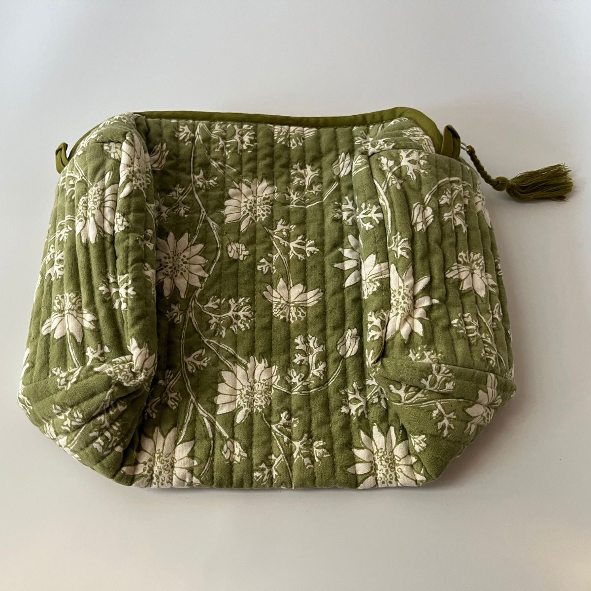 Flat lay of Flannel Flowers quilted cotton wash bags showcasing hand block printed floral patterns, premium cotton construction, and artisan craftsmanship.