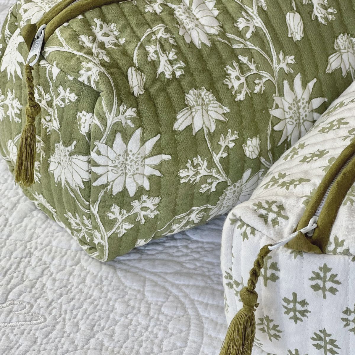 Matching set of quilted cotton toiletry bags in the Flannel Flowers print, handcrafted with zipper closures and practical storage for travel and everyday use.