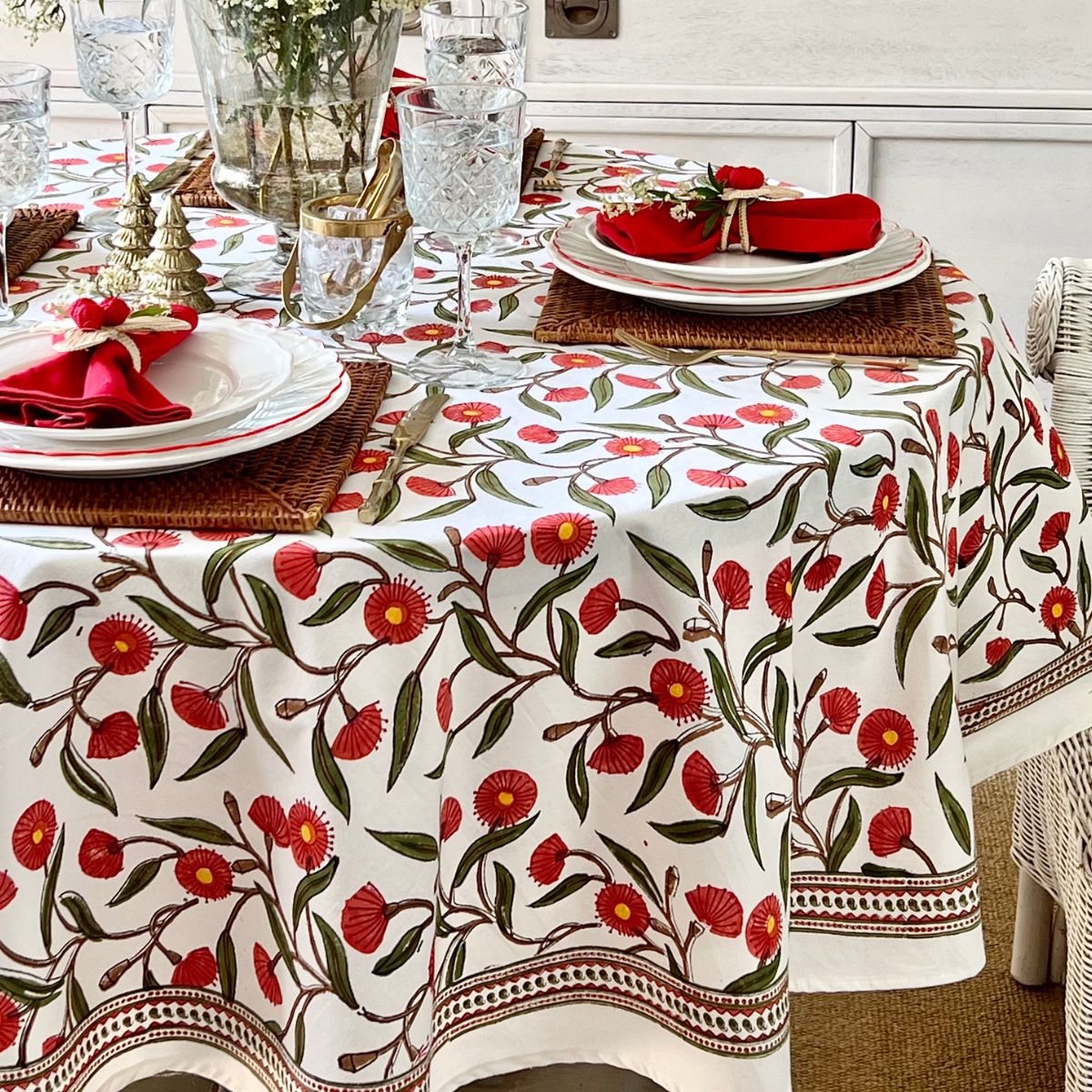 220 cm Red Flowering Gums round tablecloth creating a warm and inviting setting for Christmas lunch and holiday entertaining.