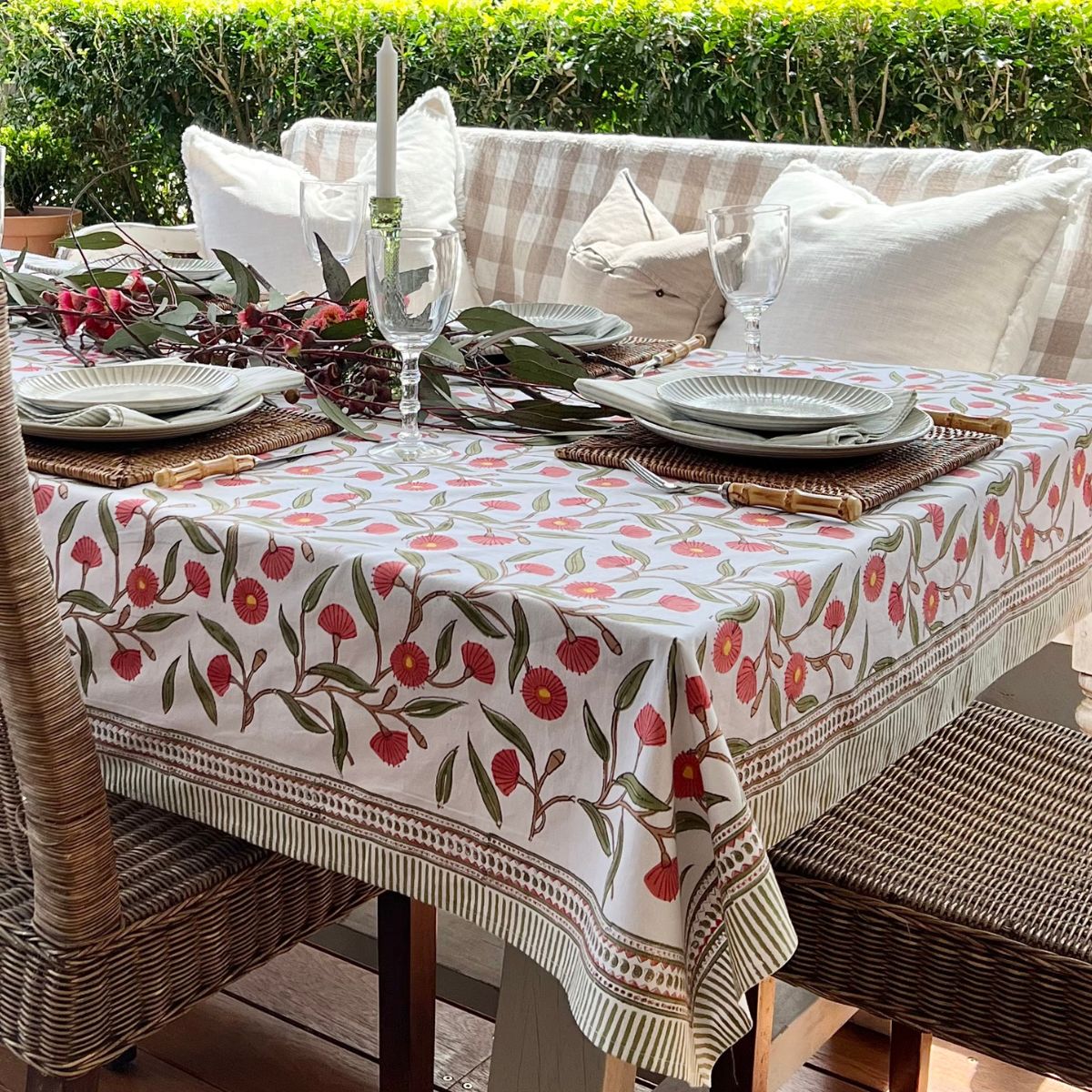 180 cm Red Flowering Gums square tablecloth styled with festive holiday decorations and Christmas table settings.