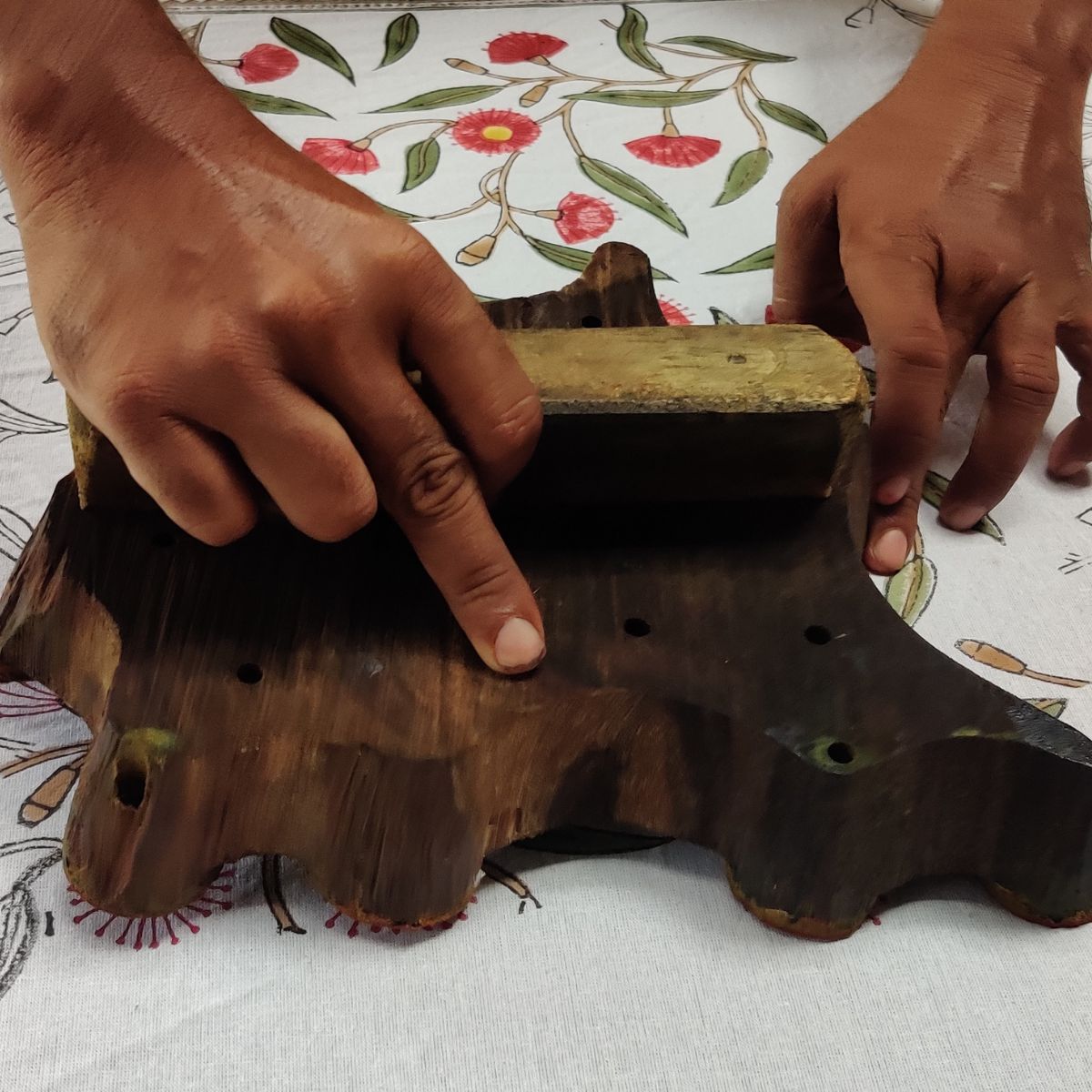 
Hand-carved wooden printing block used to create the Red Flowering Gums square cotton tablecloth collection in 180 cm and 220 cm sizes.