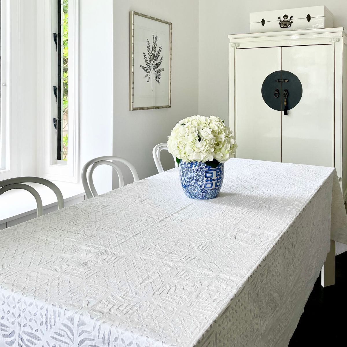 White applique cotton large tablecloth diplayed on a rectangular table